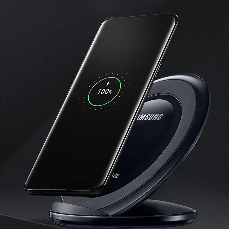 Black Qi wireless charging pad for Samsung Galaxy Note Edge on a desk.