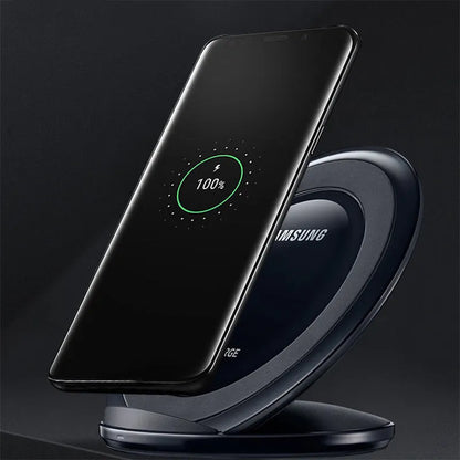 Black Qi wireless charging pad for Samsung Galaxy Note Edge on a desk.