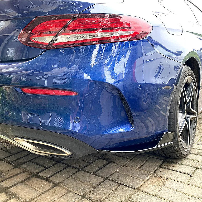 Car rear corner protectors in PP plastic, shown in piano black and carbon fibre pattern finishes