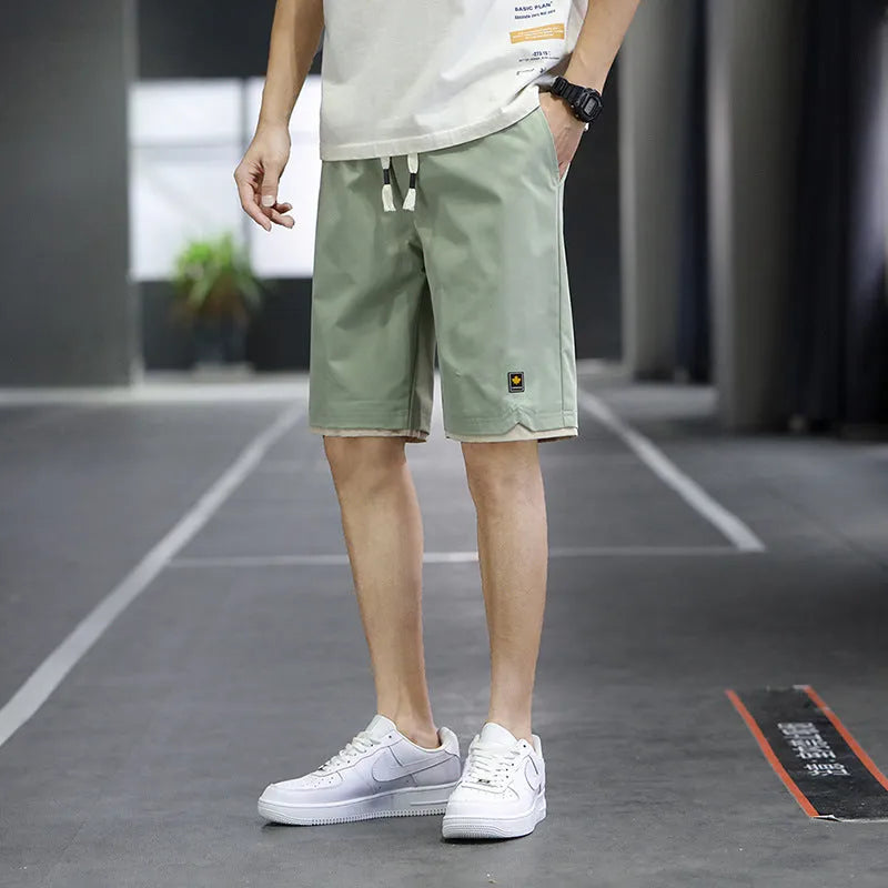 South Korea style loose straight-leg beach shorts in khaki on a plain background
