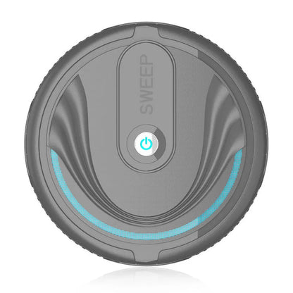 Black automatic sweeping robot vacuum cleaner with remote control on a wooden floor.
