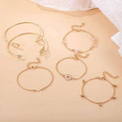 Six golden spot drill bracelets with arrow, water drop and V-shaped pendants on zinc alloy chains