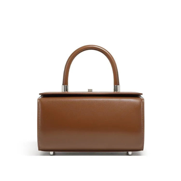 Women's leather one-shoulder crossbody bag in cowhide with clamshell design and internal phone pocket