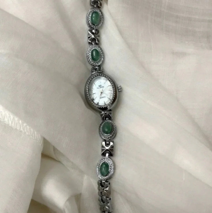 Green jade and silver ladies watch with white dial showing modern Chinese design