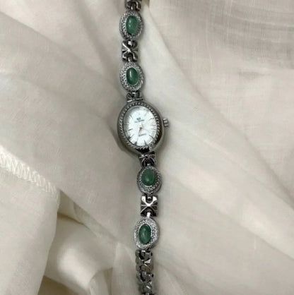 Green jade and silver ladies watch with white dial showing modern Chinese design