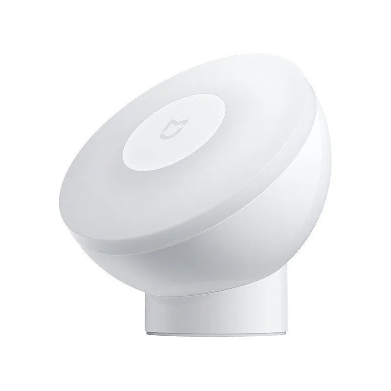 White Mijia Bluetooth bedside lamp with human body sensor on a wooden table.