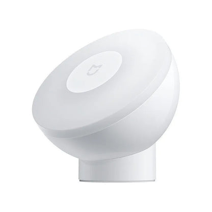 White Mijia Bluetooth bedside lamp with human body sensor on a wooden table.