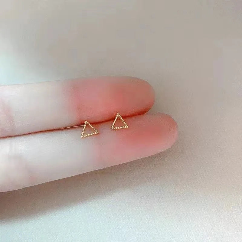 Pair of small spiral geometric ear studs with gold hollow thread finish in mixed material, shown in eight shape options.