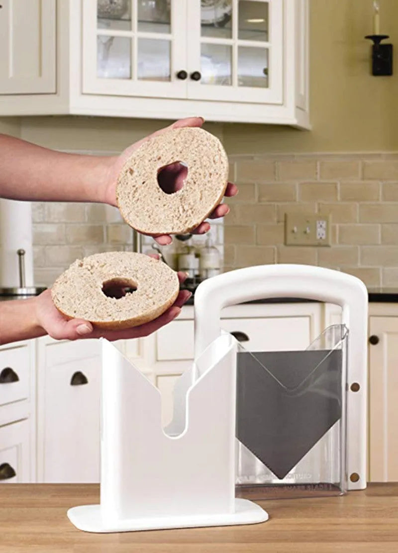 Bagel slicer and roll cutter kitchen gadget with safety shield, white plastic and stainless steel construction for effortless bagel slicing and muffin cutting