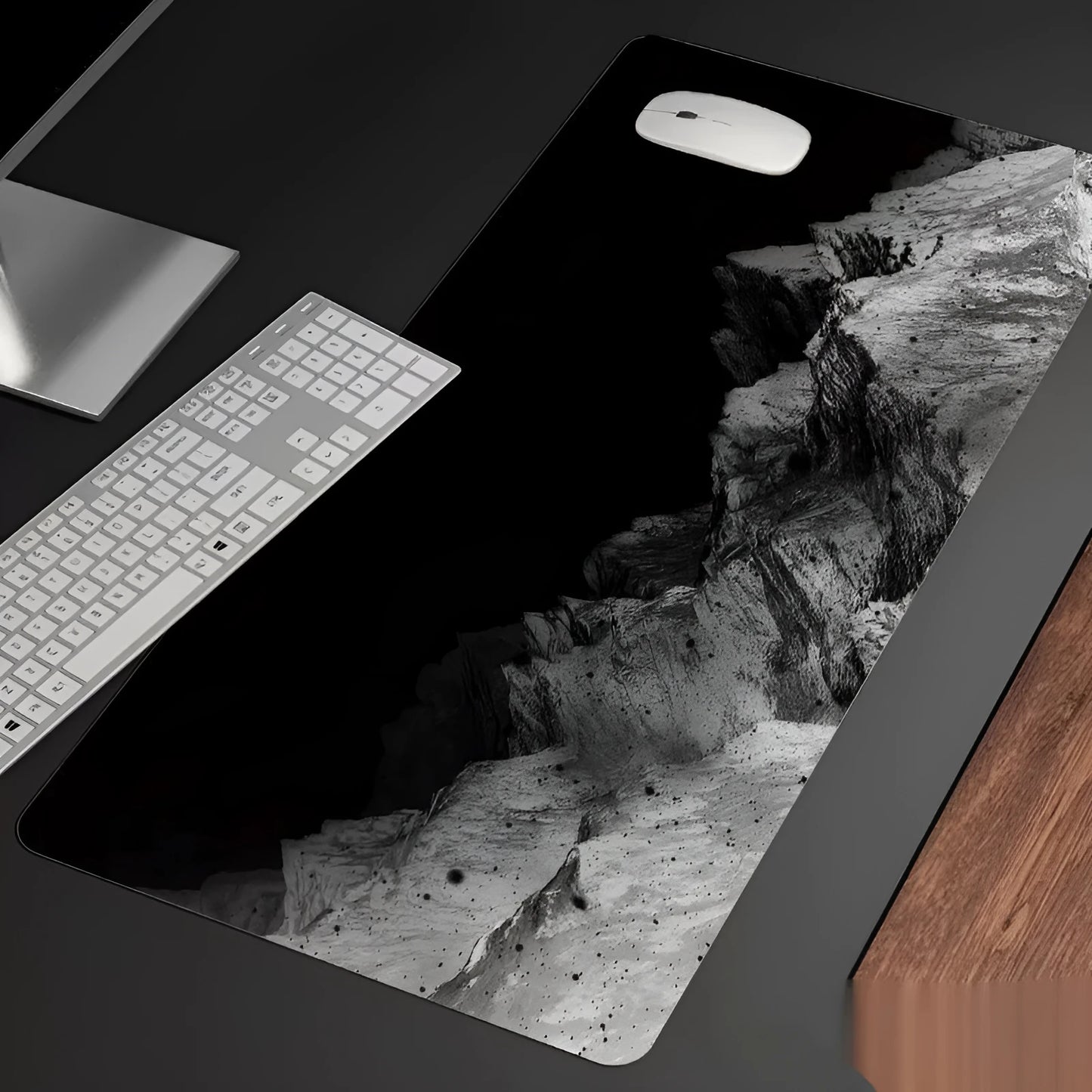 Oversized rectangular mouse pad with a printed design on a desk, next to a keyboard and mouse.