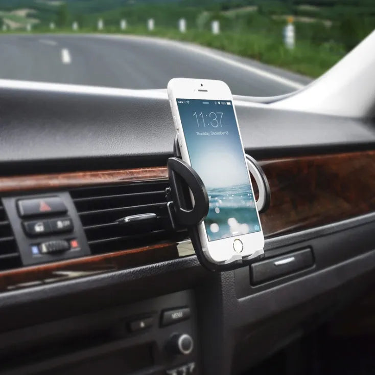 Black universal car air vent mobile phone holder attached to a vehicle vent, showing adjustable arms and 360-degree rotation.