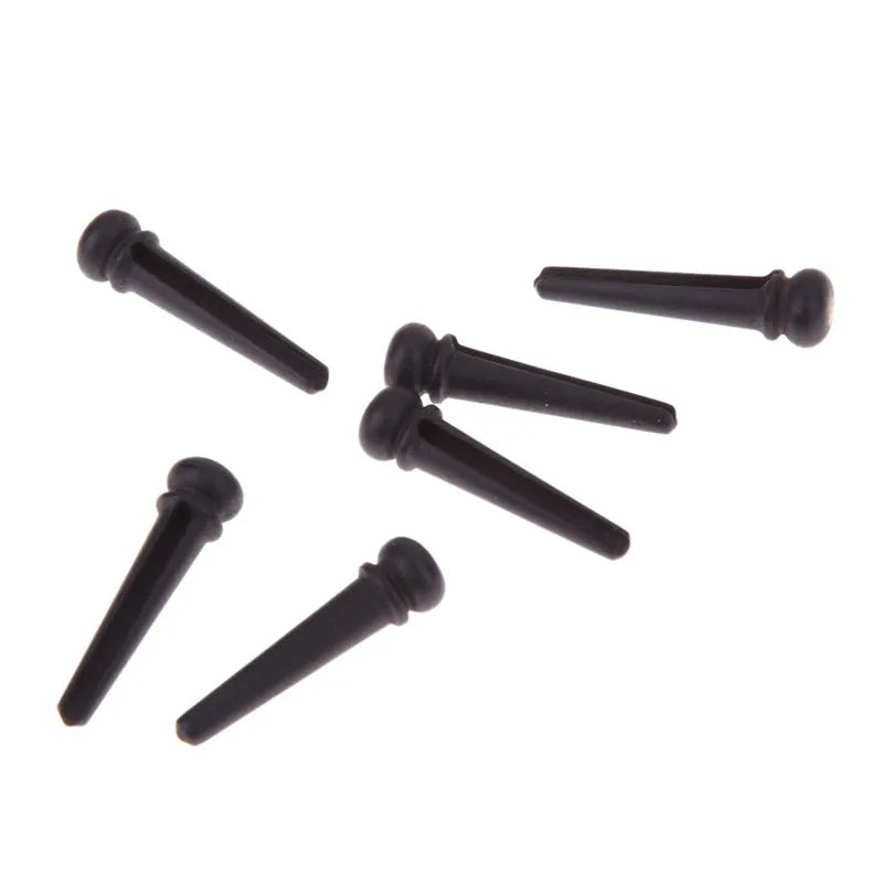 Six ebony folk guitar string nails with matte black finish and 5.3mm bayonet diameter
