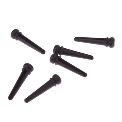 Six ebony folk guitar string nails with matte black finish and 5.3mm bayonet diameter
