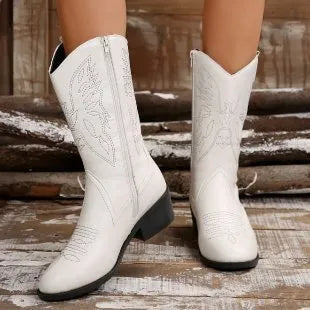 Women's black mid-calf boot with chunky rubber sole and pointed toe on a white background.