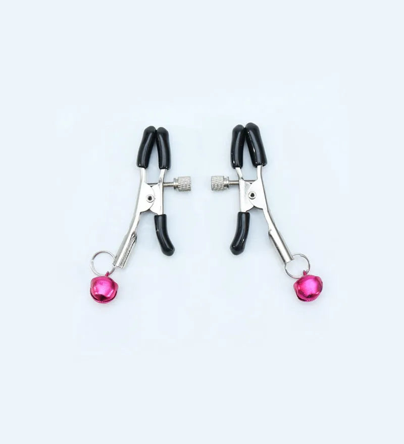 Red and purple nipple clamps with small bells and feather decorations for adult sensory play.