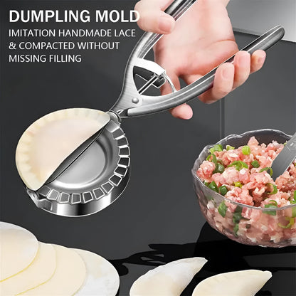 Silver stainless steel manual dumpling press with hinged handles on a wooden kitchen surface.