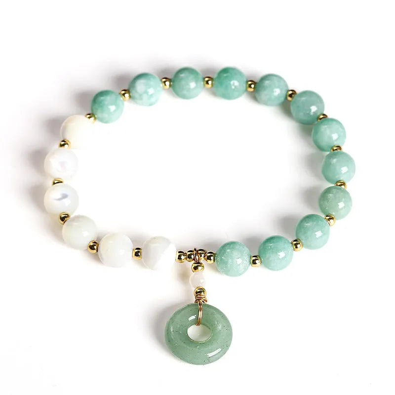Blue Burma jade bead bracelet with copper horseshoe screw safety buckle on a wrist.