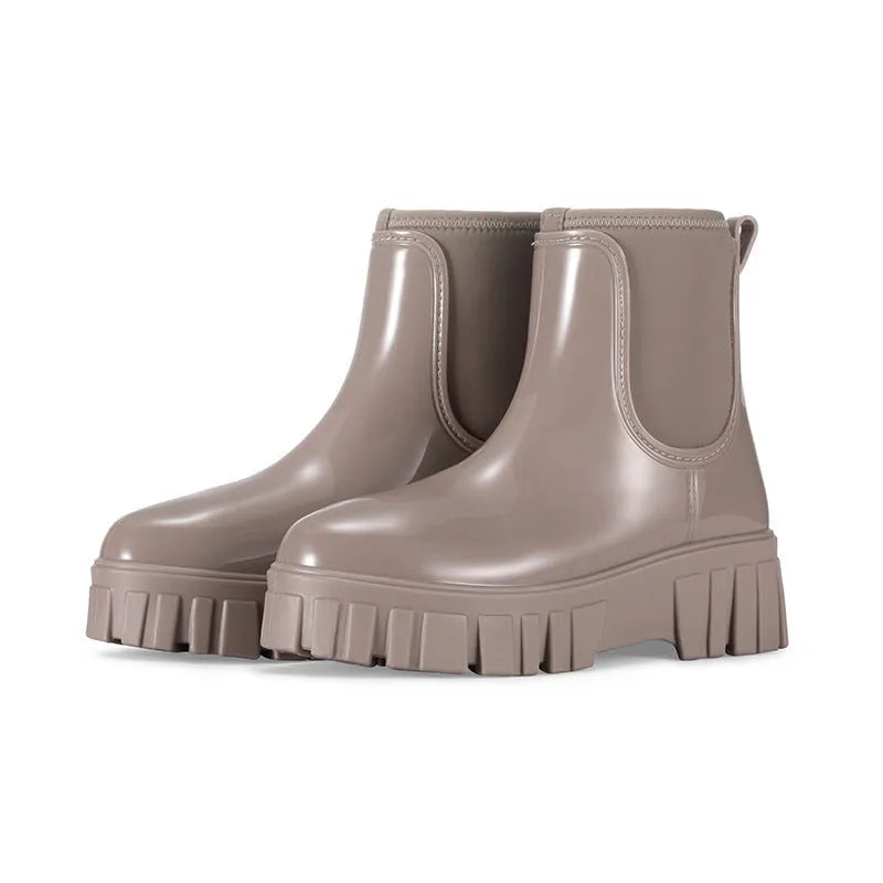 Women's creamy-white low tube PVC rain boots with a flat heel and thickening sole, shown from the side.