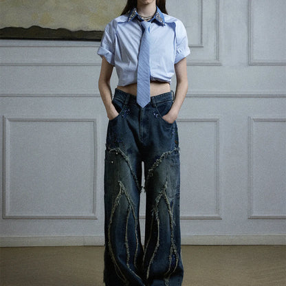 Man wearing a blue loose fit men's shirt with a diamond tie collar and patchwork striped design.