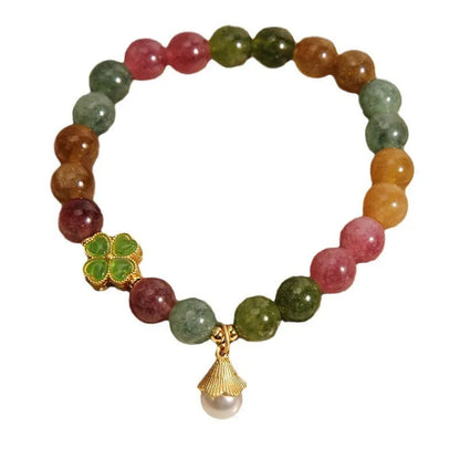 Colourful mixed-material women's bracelet with a four-leaf clover charm and a pearl pendant on a geometric chain.