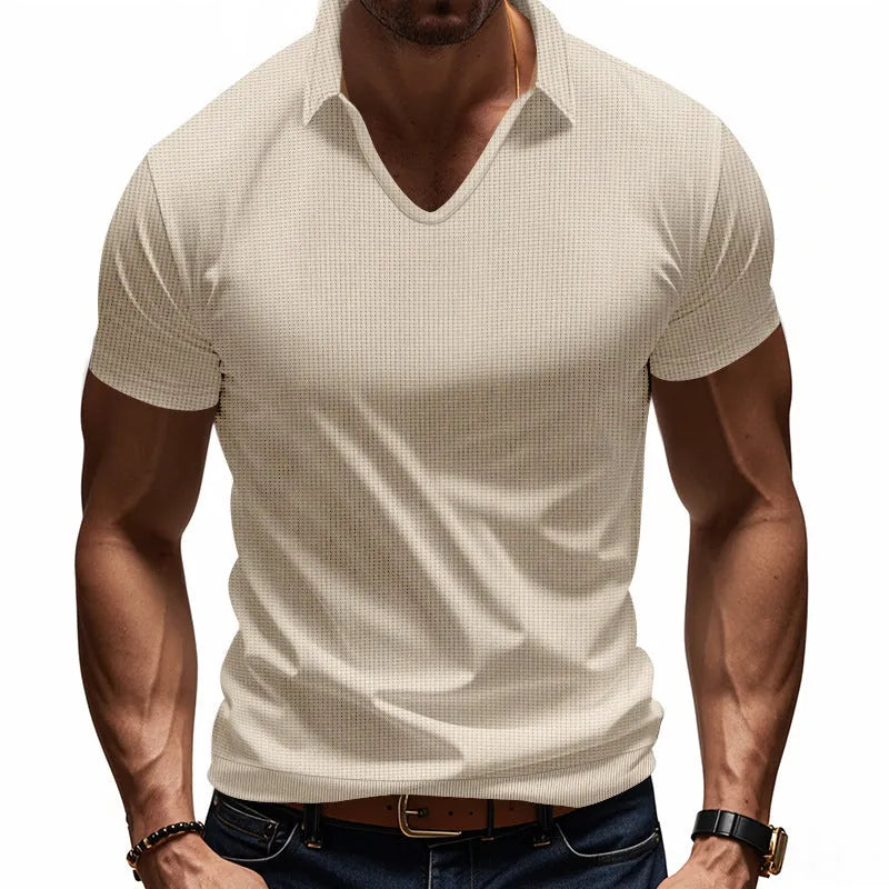 Man modelling a loose-fit apricot coloured V-neck short-sleeve T-shirt for casual summer wear.