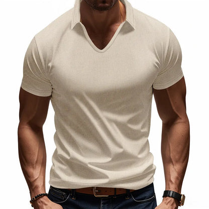 Man modelling a loose-fit apricot coloured V-neck short-sleeve T-shirt for casual summer wear.