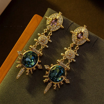A pair of gold-coloured geometric stud earrings with round details and a retro style.