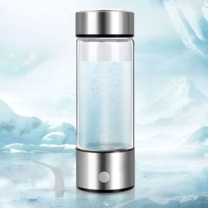 Portable hydrogen water bottle with glass chamber and stainless steel components showing electrolysis bubbles