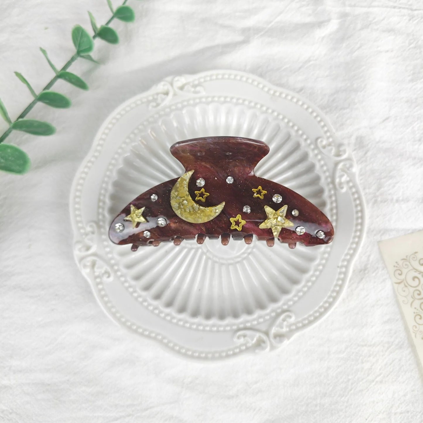Oversized star barrettes in starry sky colours showing minimalist design and irregular elements
