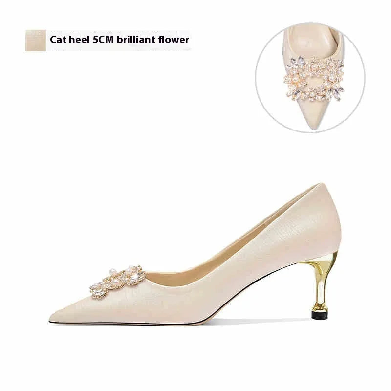 French crystal bridal high heel pump with rhinestones on cloth upper, showing pointed toe and stiletto heel.