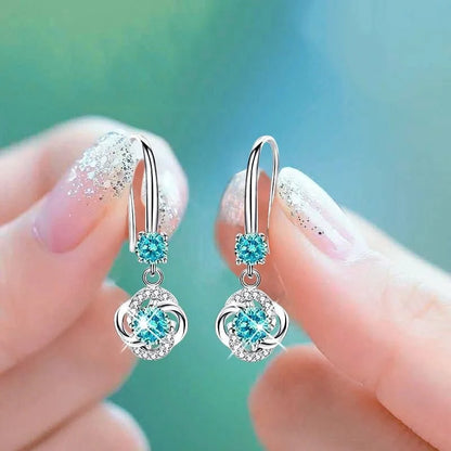 Silver stud earrings with four-leaf clover design and fairy ear hooks