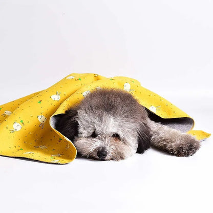 Double-sided cotton wool pet blanket in dinosaur print showing reversible construction