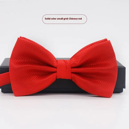 A solid colour pre-tied bow tie with an adjustable neck strap, shown in a classic flat head shape.