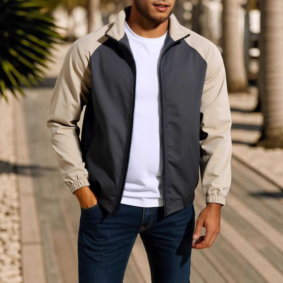 Man wearing a green loose-fit casual jacket with a stand collar and raglan long sleeves.