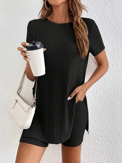 Woman wearing a grey ribbed cotton crew neck top and matching shorts from a two-piece suit set.
