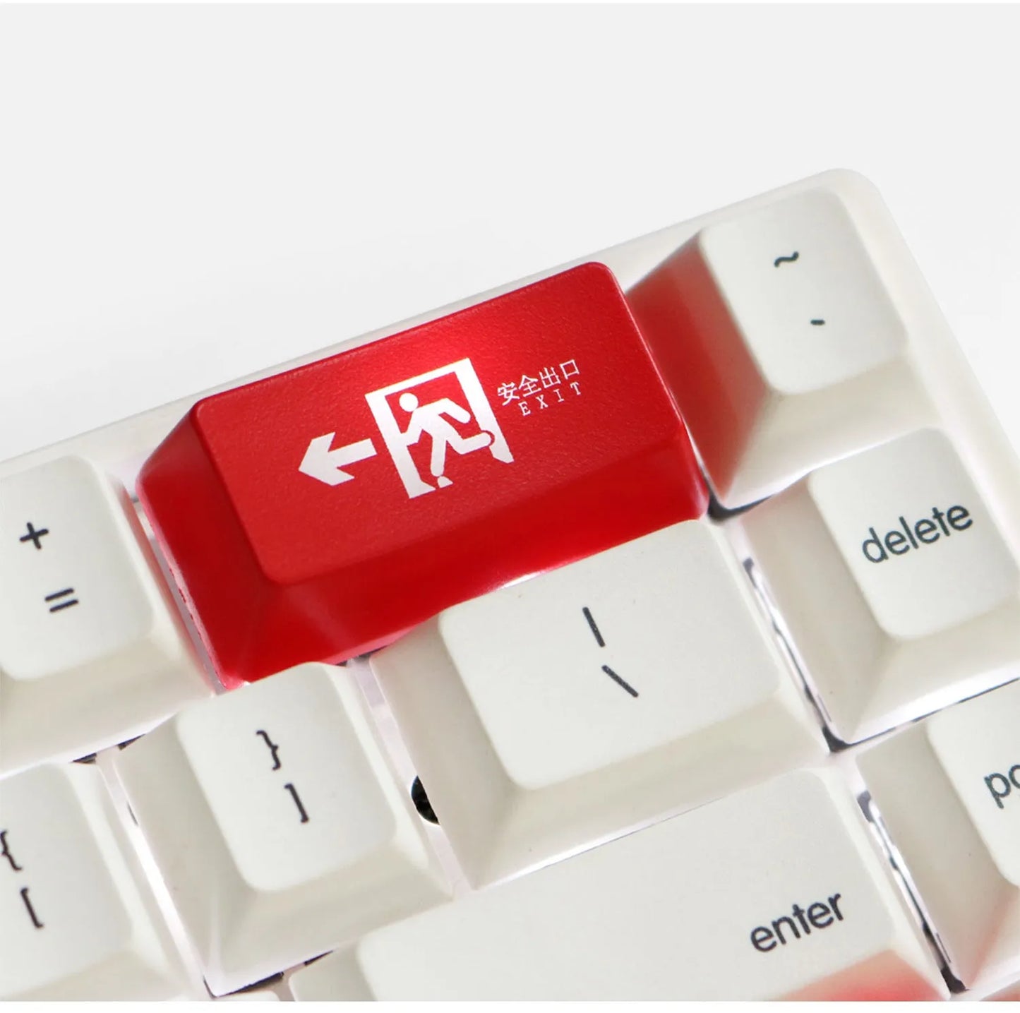 Transparent keyboard key cap with safety evacuation exit symbol design
