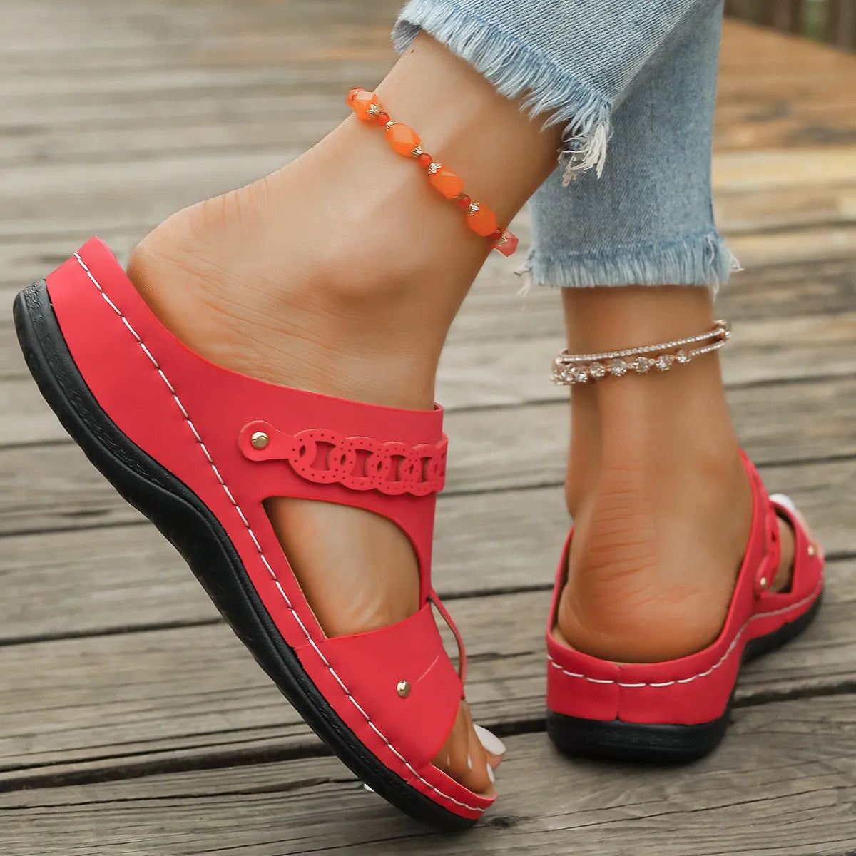 Beige Roman style slippers with a fish mouth toe, slope heel, and rubber sole.