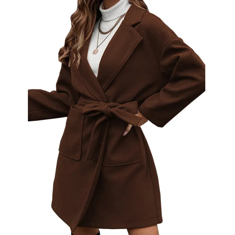 Brown loose fit minimalist coat with lapel buttons and integrated belt, showing regular sleeves and split design