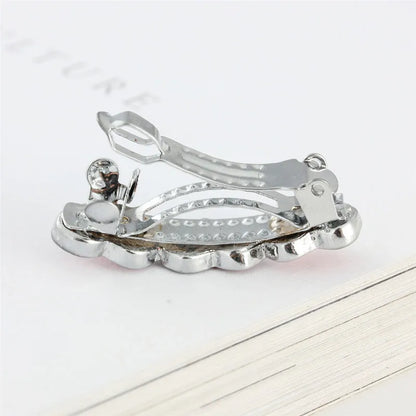 A 3cm long peach heart shaped hair clip with rhinestones and a small dog charm, on a white background.