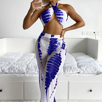 Women's black printed three-piece swimsuit set with mesh trousers laid flat.