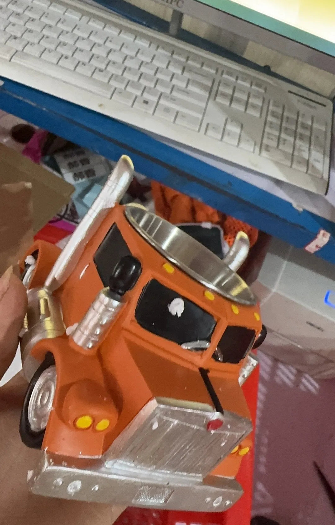 Resin semi-truck shaped coffee mug in orange colour with 11-ounce capacity