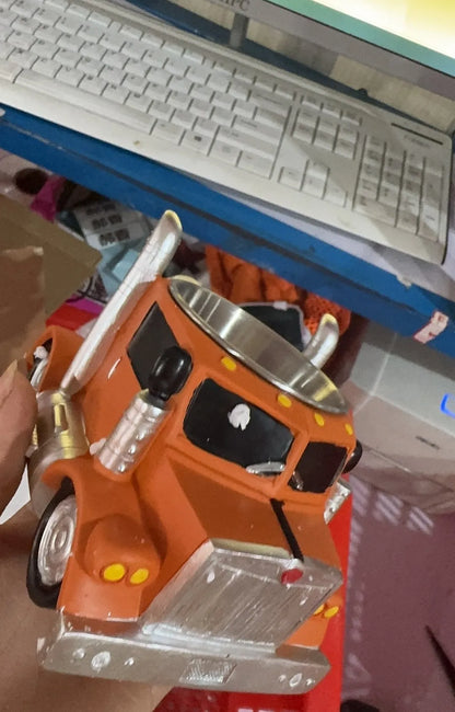 Resin semi-truck shaped coffee mug in orange colour with 11-ounce capacity