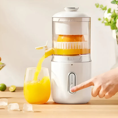 Fresh green portable USB electric juicer and blender for oranges and vegetables on a kitchen counter.