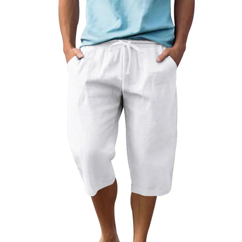 Men's loose-fit linen shorts in a solid colour with a drawstring waist and cropped leg length.
