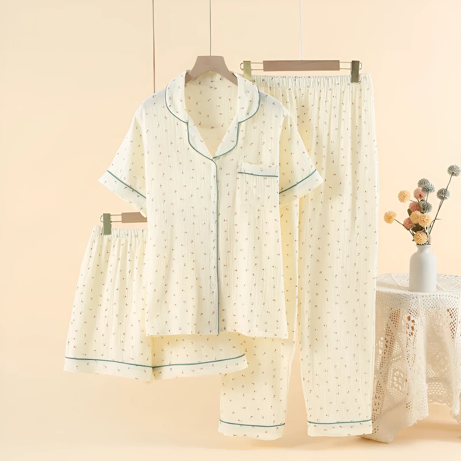 Women's garden gold cotton three-piece pajama set with lapel shirt and trousers on a hanger.