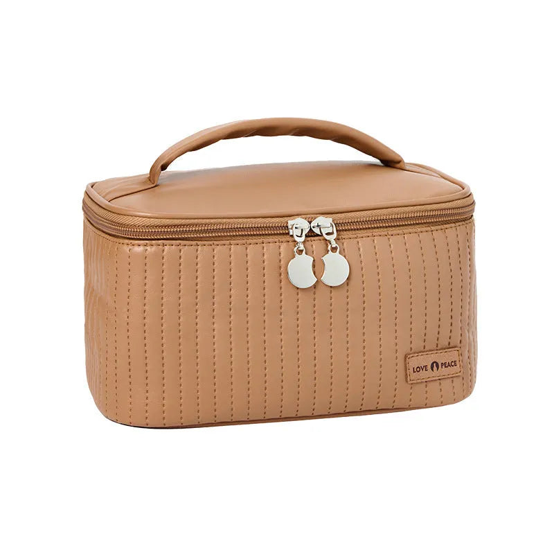 Open-top pastel pink PU leather makeup bag with a flat base, showing interior space.