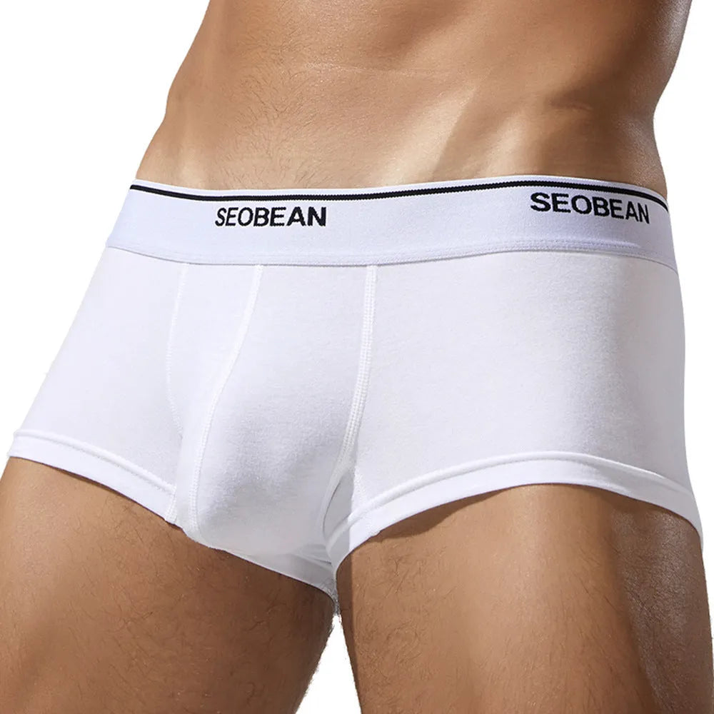 Men's solid colour cotton low waist boxers in sizes M to XXL.