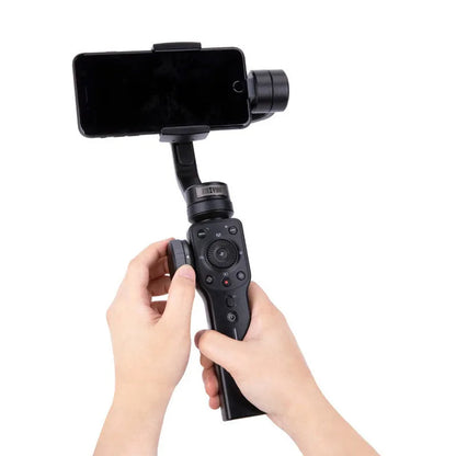 Black mobile phone handheld stabiliser gimbal on table with smartphone mounted