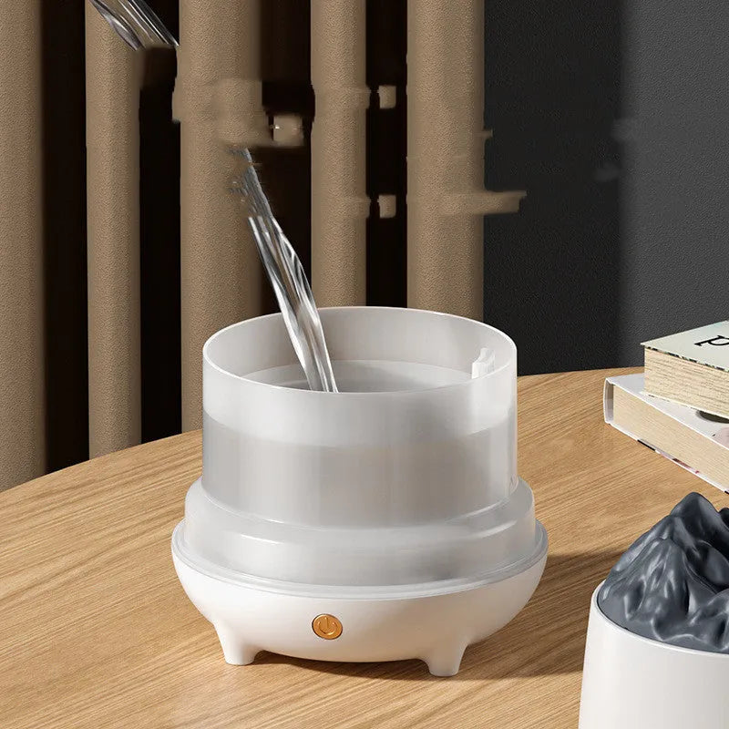 Volcano-shaped white ultrasonic humidifier with mist output on wooden surface