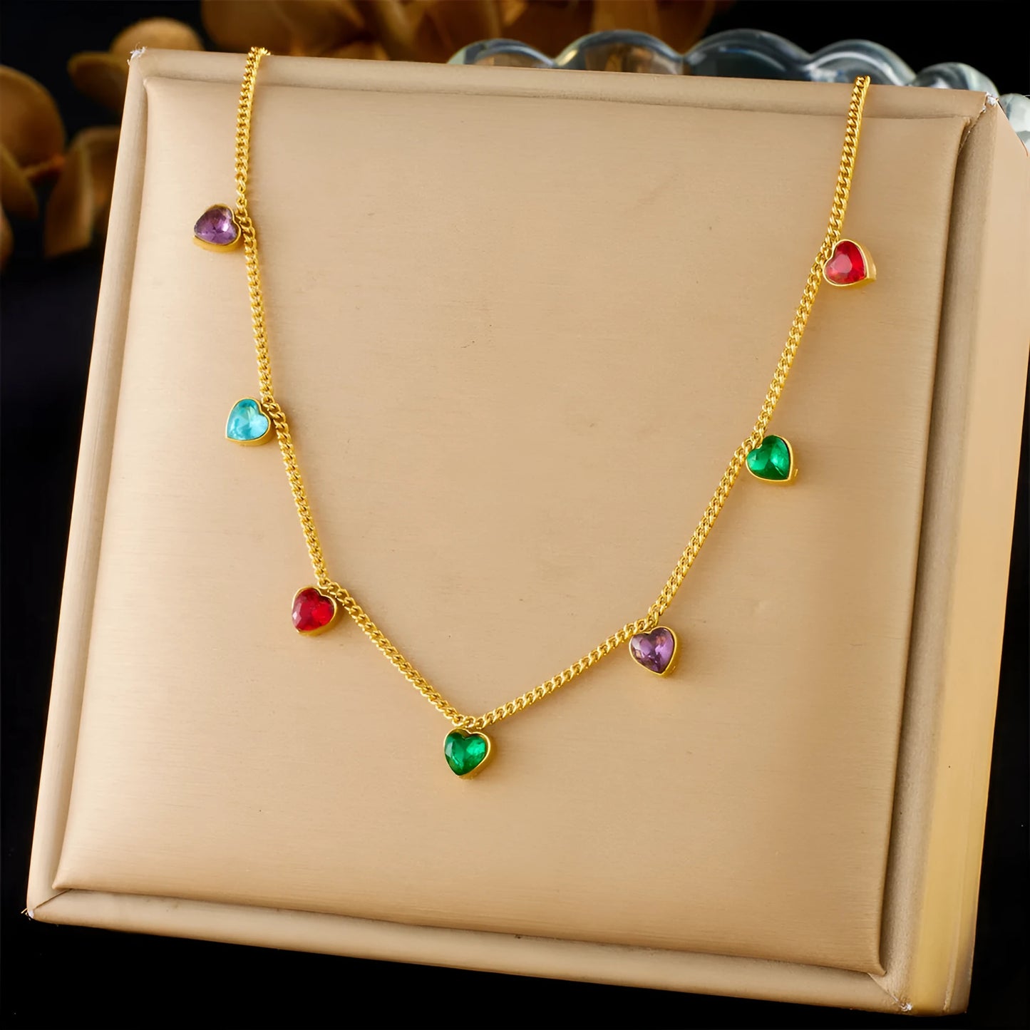Women's gold-plated heart necklace with adjustable chain on white background